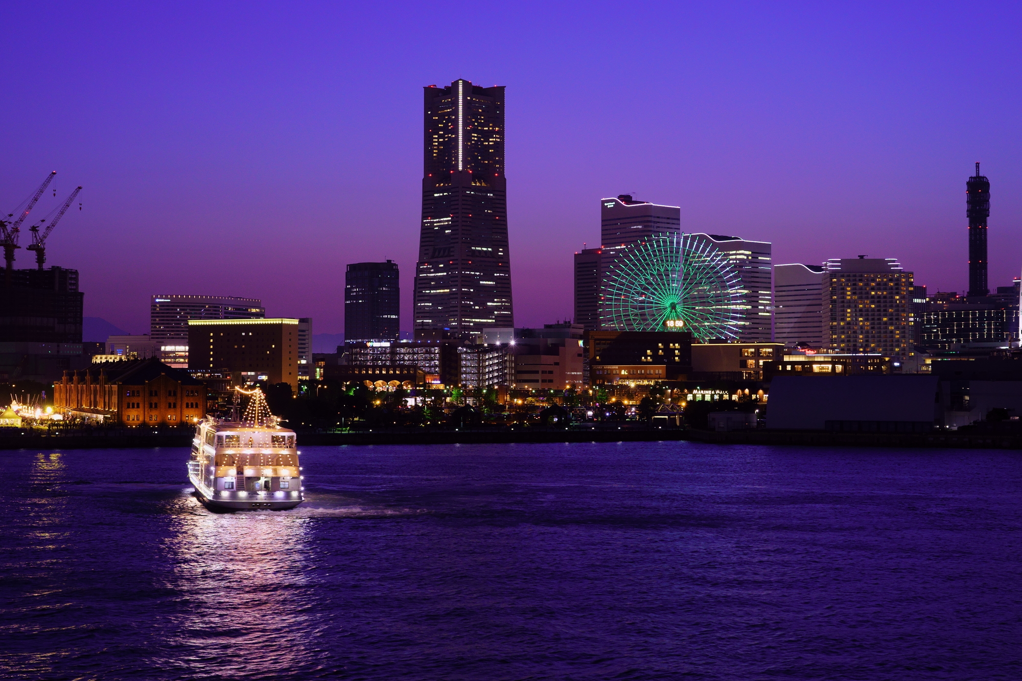 横浜のきれいな夜景とライトがきれいなクルーザー