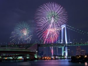 ライトアップされた橋とその上に打ち上げられる花火