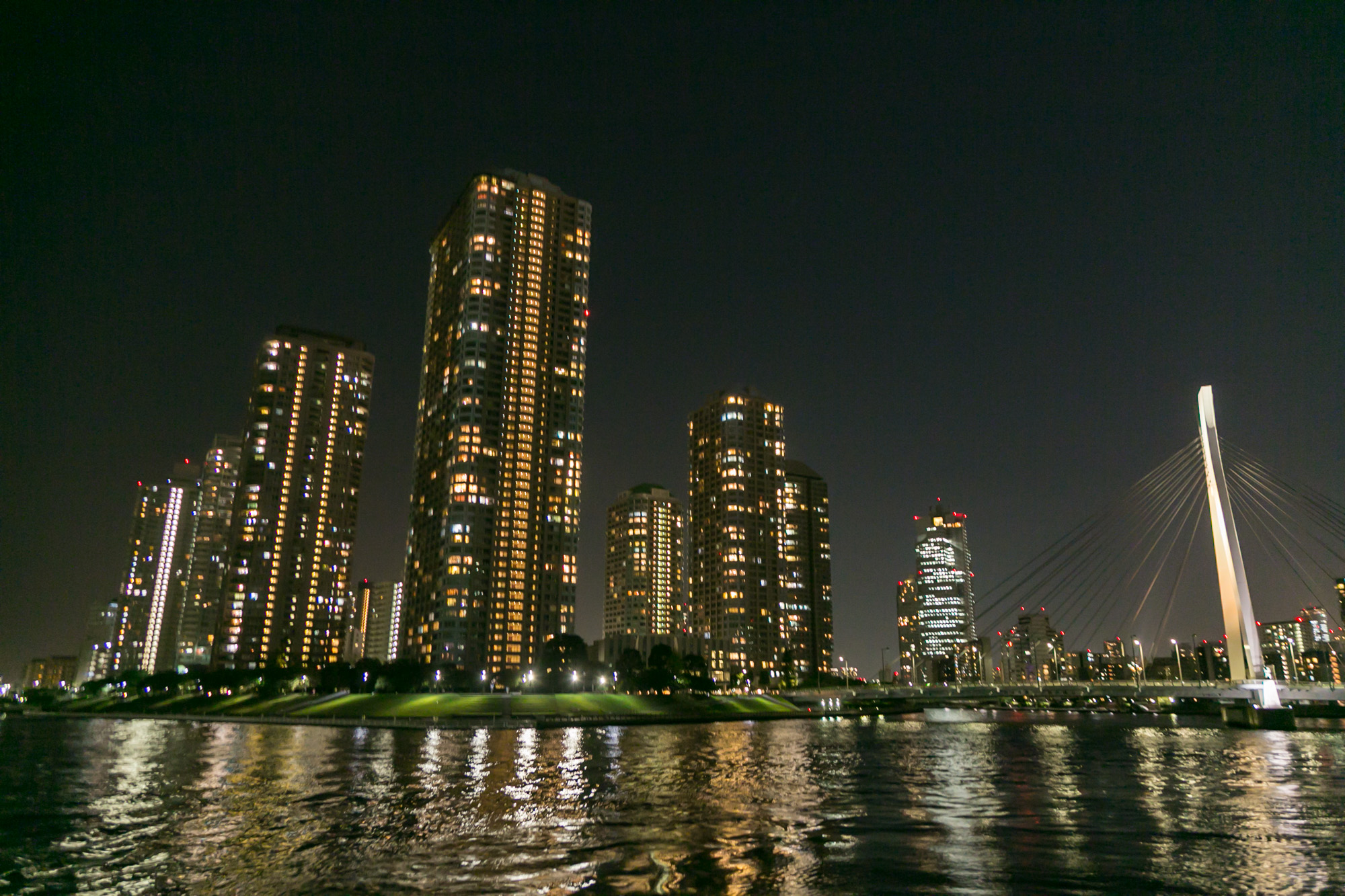 河川上から眺める夜の高層ビル群