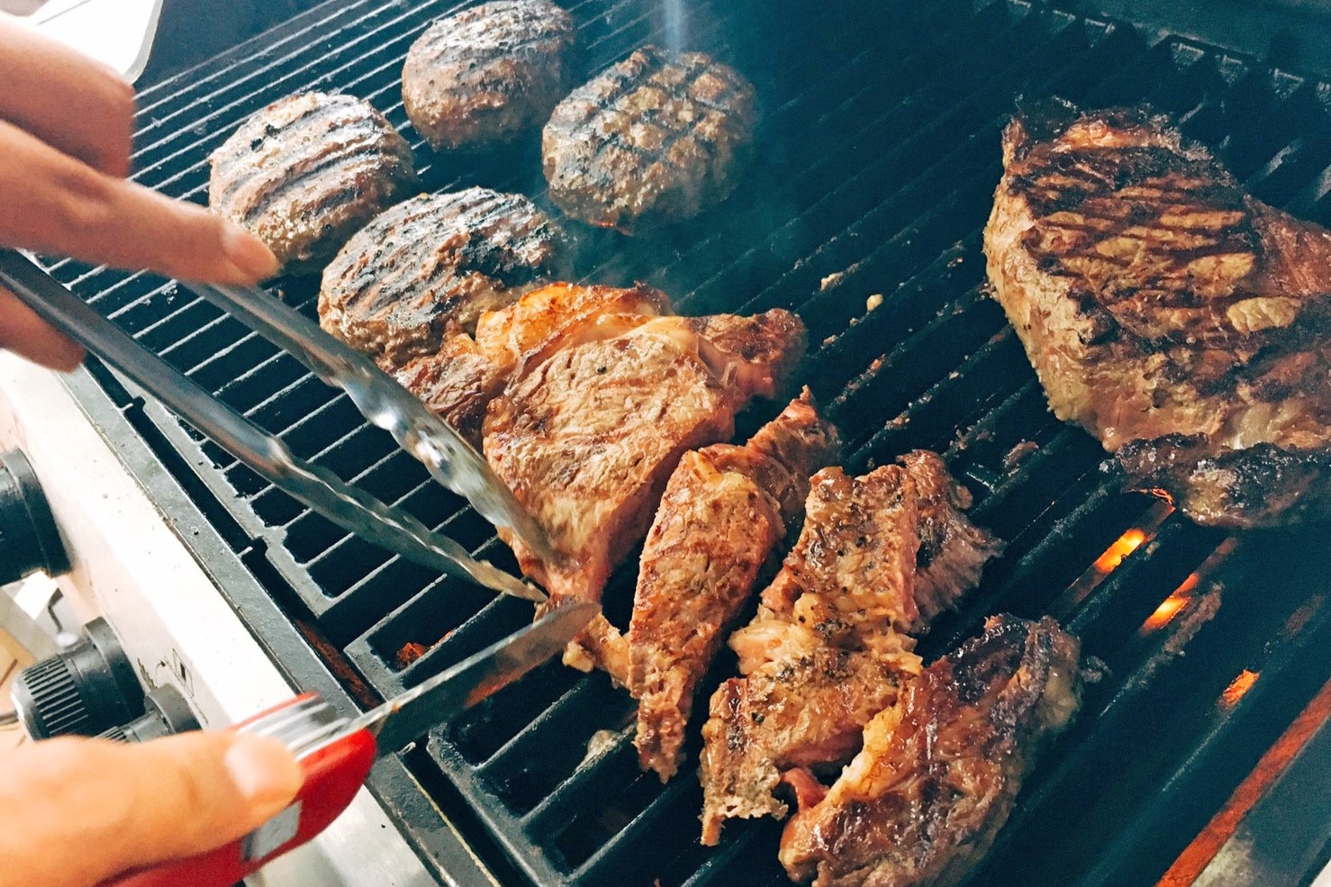 こだわりのアメリカンBBQグリルでジューシーなお肉を焼く様子