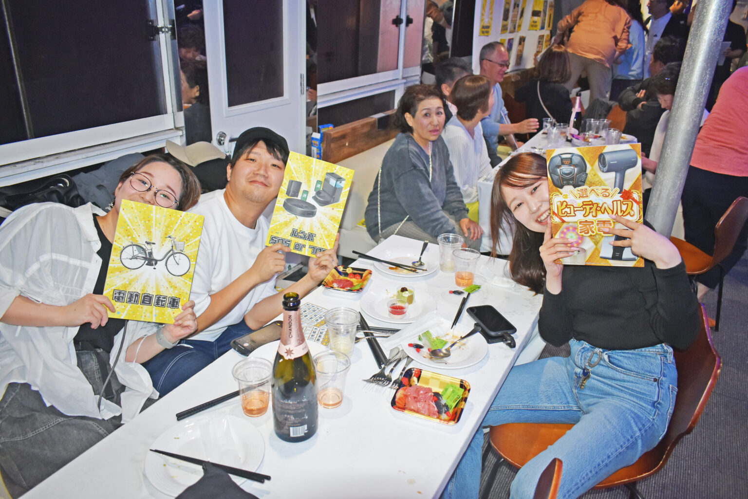 ビンゴ大会の景品を手にする参加者たち