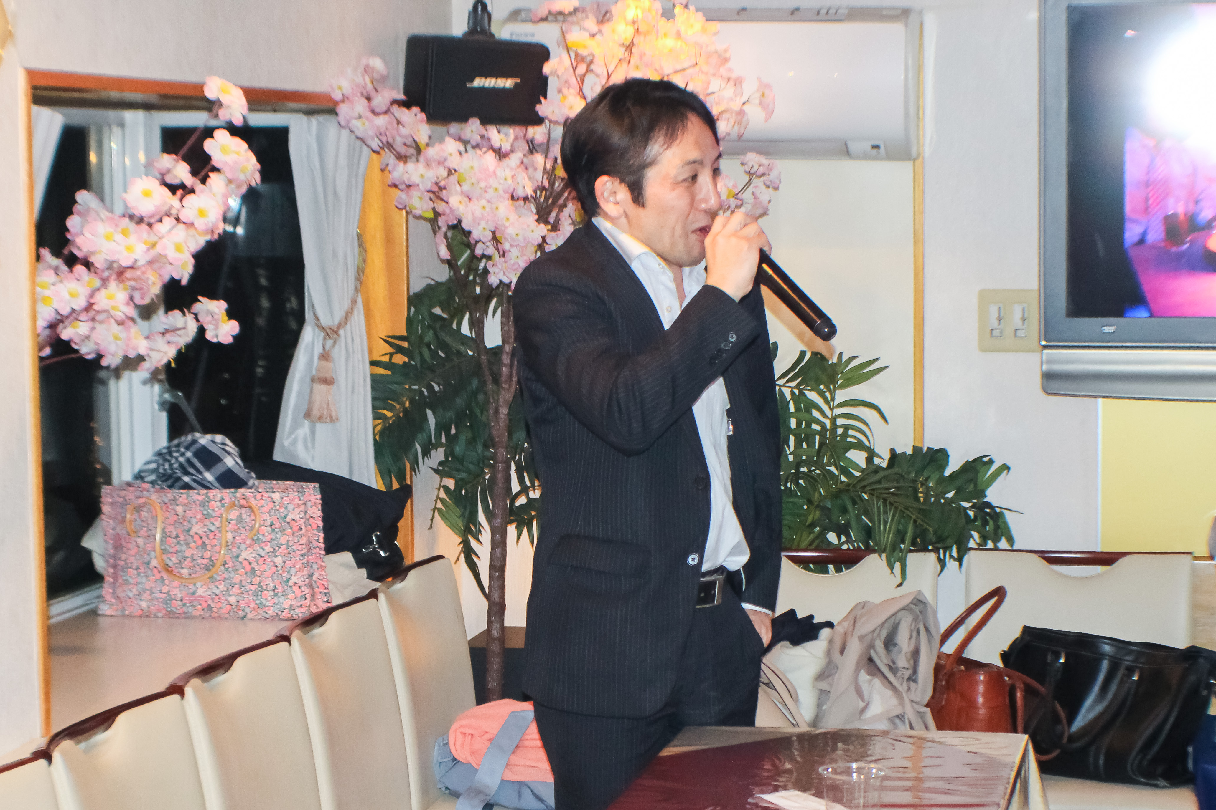 マイクで話す男性