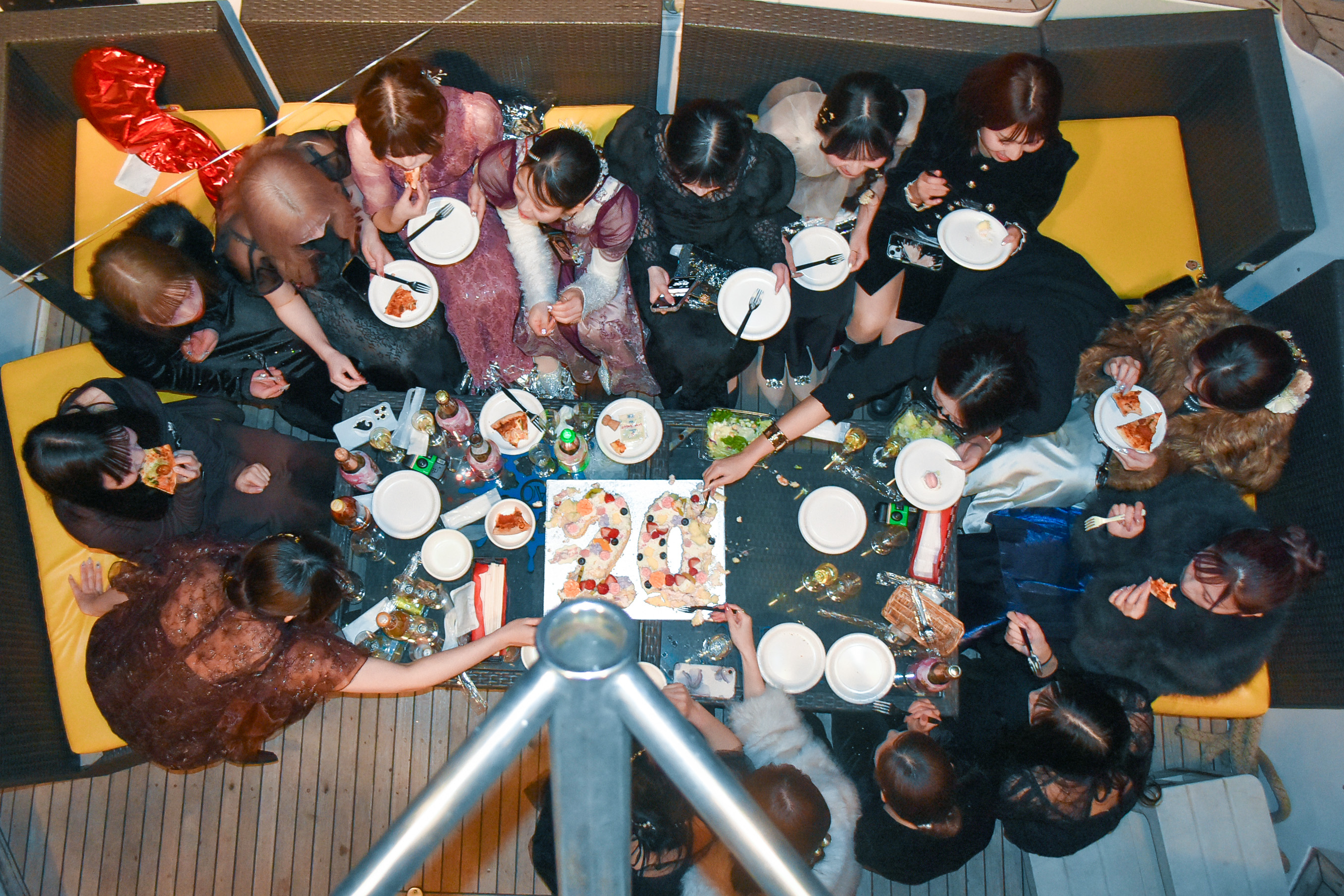 デッキでケーキを食べる女子