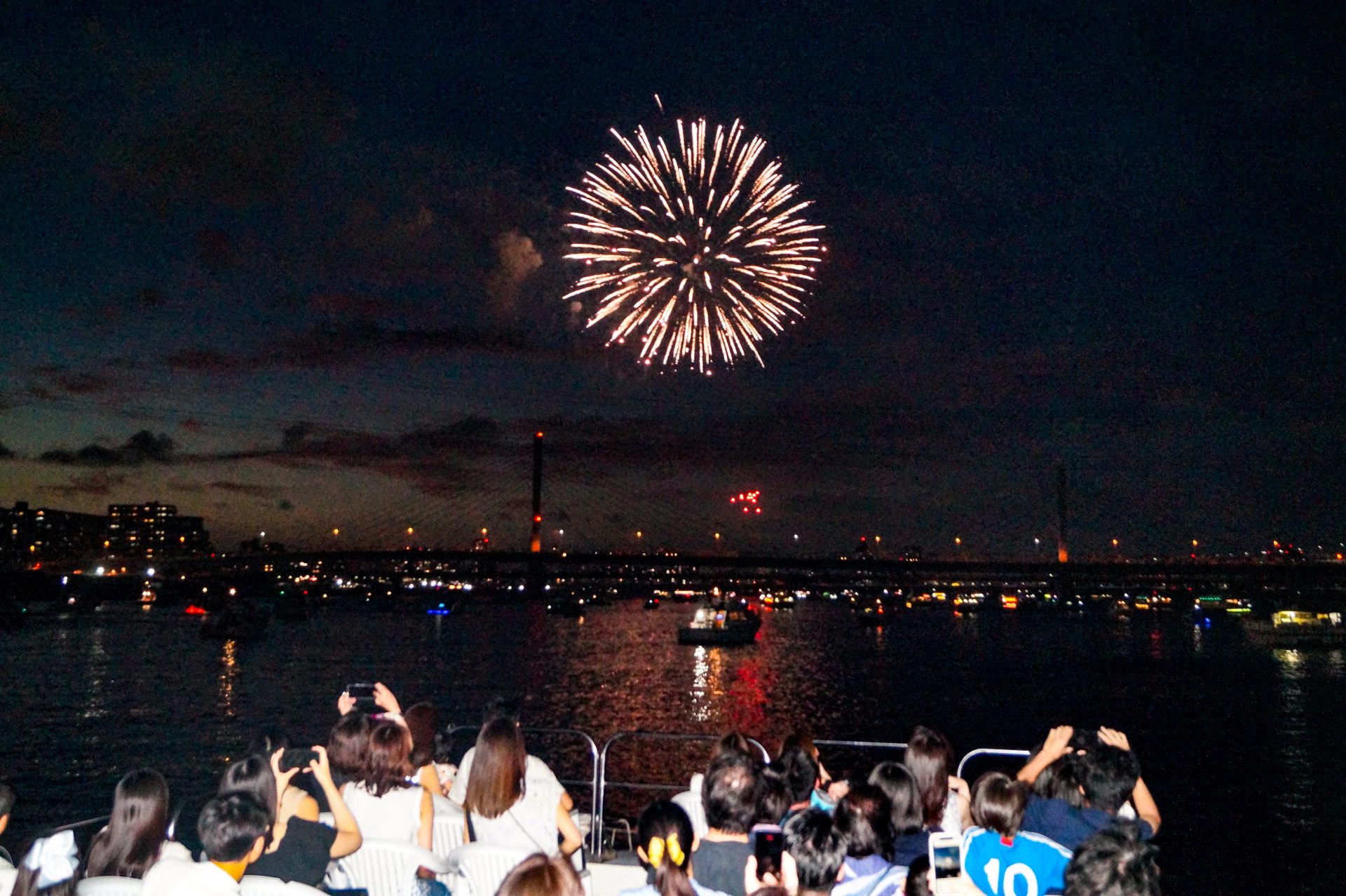 江東花火を船から眺める人々